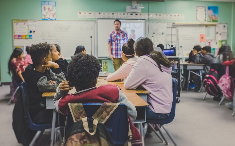 males, class, table, man, seat, women, real people, men, 4K, standing, education, classroom, woman, school, indoors, boys, casual clothing, rear view