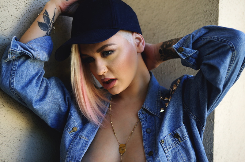leisure activity, baseball caps, tattoo, real people, adult, lifestyles, front view, hood - clothing, blue, denim, side shave, face, blonde, s, clothing