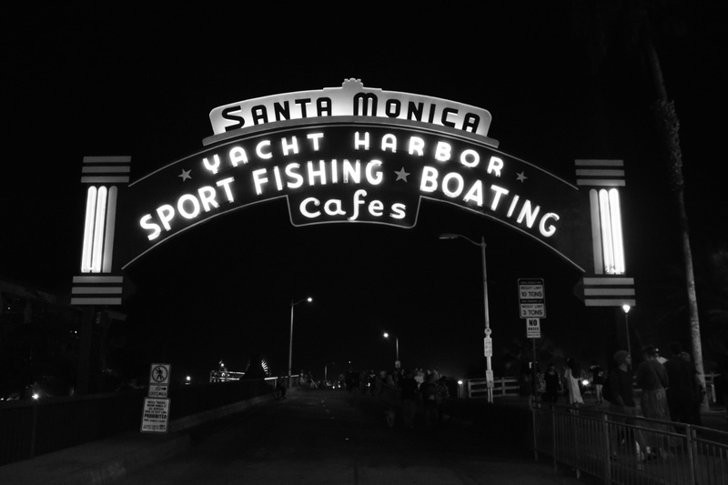 western script, information, text, building exterior, black and white, script, information sign, street, architecture, city, sign, states, low angle view