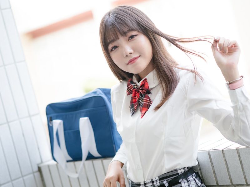 one person, looking at camera, hairstyle, bow-tie, portrait, depth of field, beauty, focus on foreground, looking at viewer, hair, touching hair, smiling