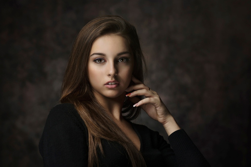 black background, teenager, beauty, brown hair, one person, hairstyle, body part, looking at camera, beautiful people, front view, indoors, hair, hand