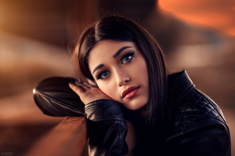focus on foreground, contemplation, brunette, women, young adult, blue eyes, leather jacket, young women, clothing, leather, black hair, adult, 1080P
