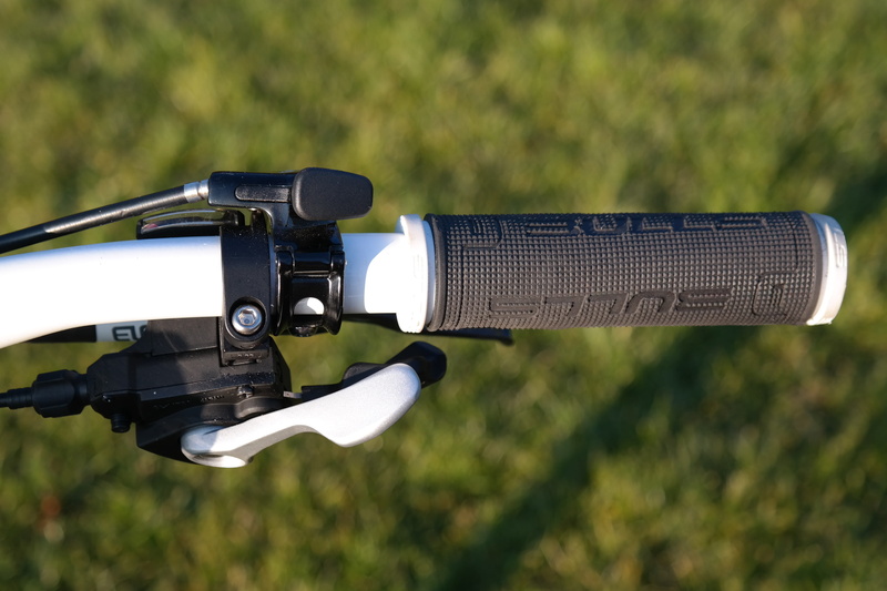 arts culture and entertainment, gear lever, close-up, outdoors, bike, side view, component, sunlight, selective focus, photography themes, bicycle handlebar