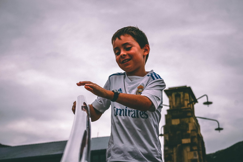 person, one person, outdoors, childhood, low angle view, fly, cloud - sky, daylight, little, front view, gray, grab, emirates, kid, white, young men, boy