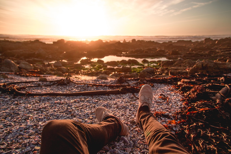 sunrise, men, person, rock, sunset, leisure activity, ocean, outdoors, seashore, limb, sky, real people, south africa, leg, ground, shoe, orange, lens flare
