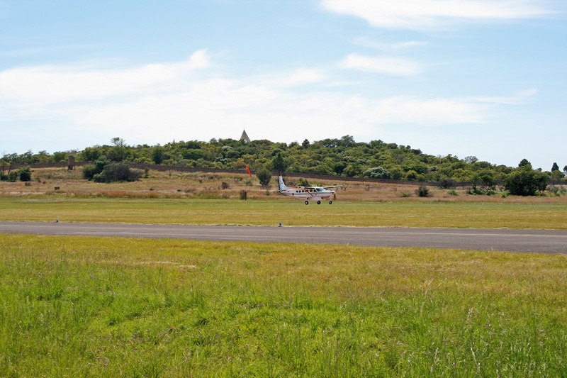 cessna caravan, aircraft, non-urban scene, landing, airshow, sky, environment, display, built structure, day, water, field, growth, approaching aircraft