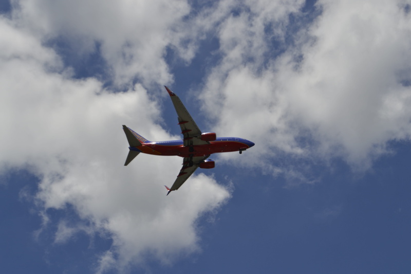 red, mode of transportation, landing gear, transportation, airliner, southwest, trip, plane, mid-air, airshow, on the move, flying, aerobatics, passenger plane