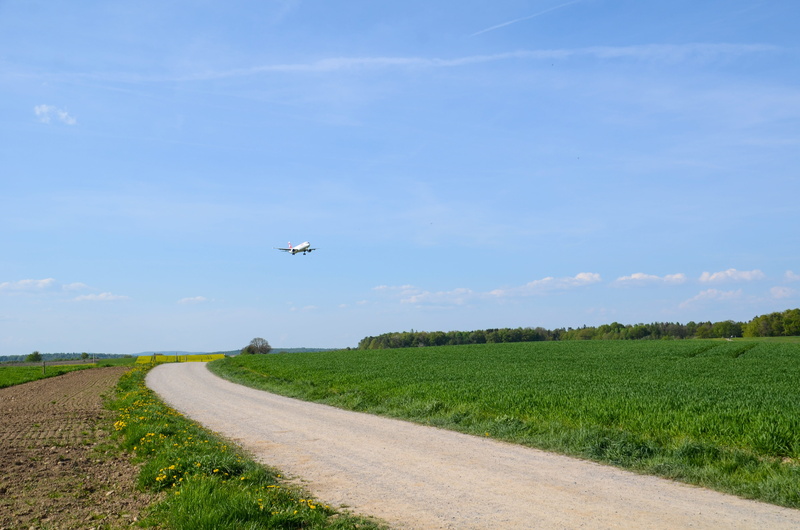 aerospace industry, aircraft, rural scene, direction, road, field, agriculture, blue, scenics - nature, away, airplane, air vehicle, landscape, flying