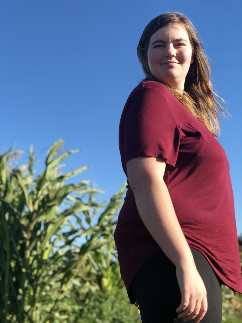 strong, plant, women, confident, lifestyles, casual clothing, one person, standing, sky, side view, hairstyle, 4K, field, looking at camera, three quarter length
