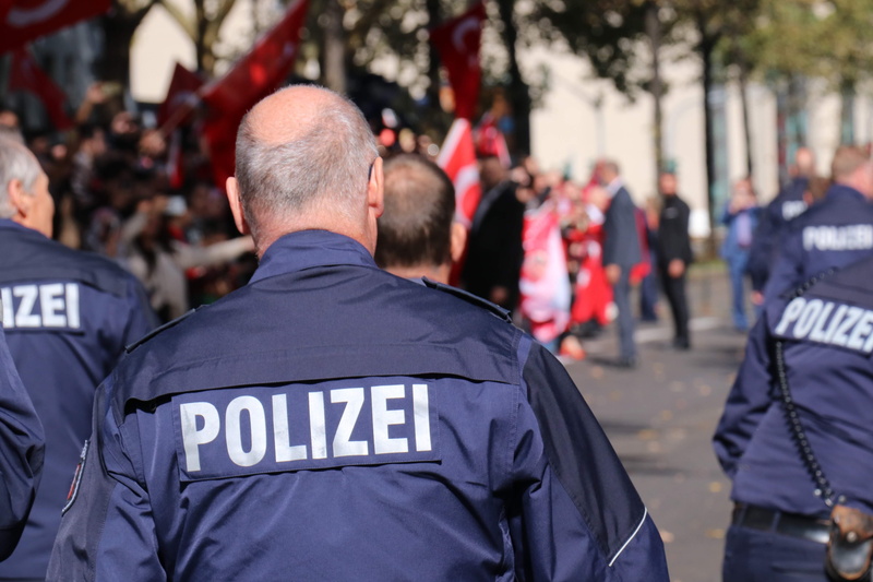 large group of people, safety, responsibility, standing, real people, watching, spectator, polizei, crowd, officer, government, adult, uniform, men, city