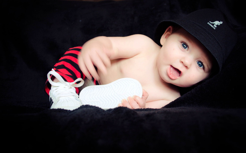 toddler, looking at camera, lifestyles, indoors, childhood, s, lying down, portrait, headshot, clothing, one person, innocence, young, males, men, black