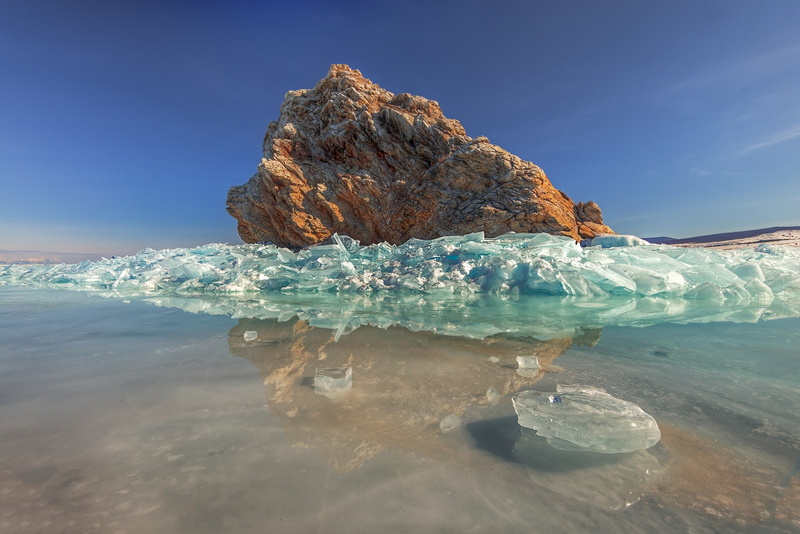 sky, blue, day, tranquility, beauty in nature, nature, rock formation, waterfront, iceberg, water, no people, sea, ice, outdoors, land, rock - object, idyllic