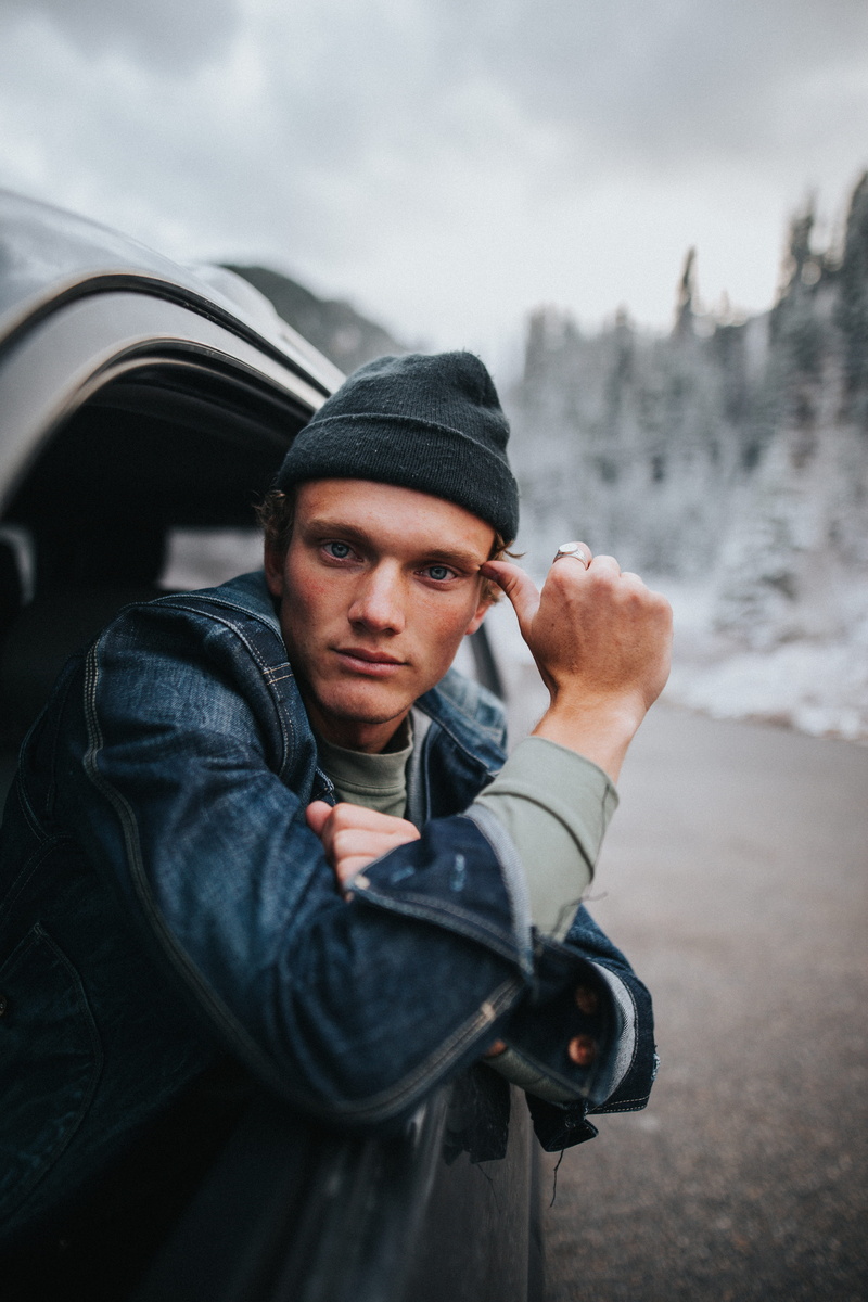 cold temperature, looking at camera, vehicle, window, cap, one person, driving, inside, real people, waist up, contemplation, mode of transportation, young adult