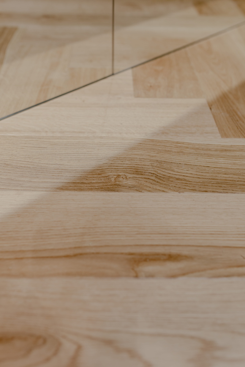 home interior, oak floor, surface level, hardwood floor, day, table, close-up, oak parquet, focus on foreground, floor, beautiful, wood grain, no people