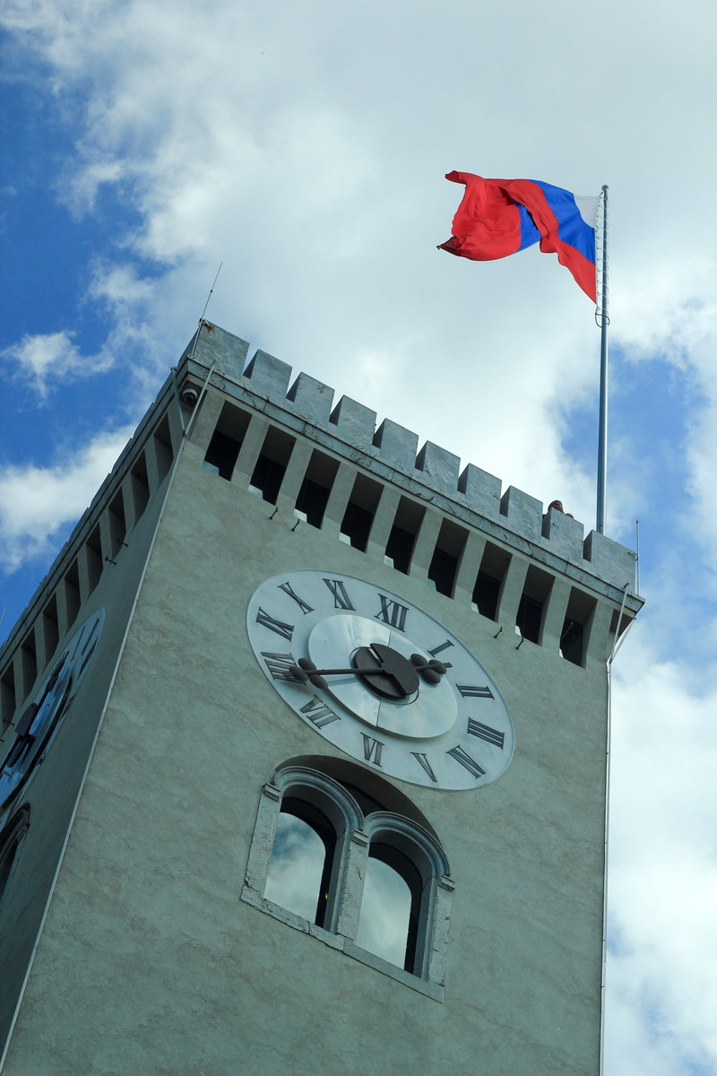 building, ljubljana, clock, flag, animal representation, time, tower, no people, building exterior, slovenia, high, representation, wind, day, castle, art and craft