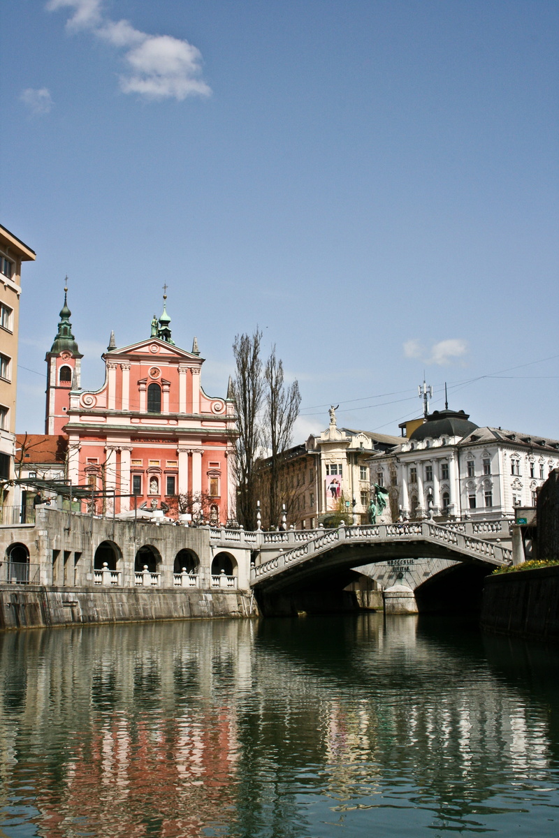 clear sky, river, travel destinations, column, sky, arch, bridge, classical, waterfront, arch bridge, slovenia, architecture, pink, building exterior, lamp