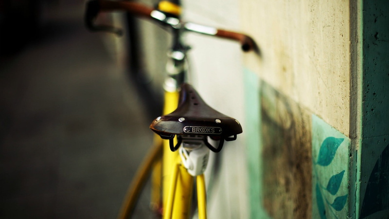 music, still life, indoors, day, wall - building feature, machinery, close-up, metal, mode of transportation, brooks saddle, selective focus, yellow, blurred