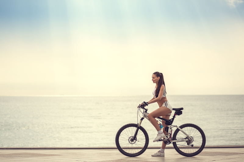 transportation, cycling, water, horizon over water, bicycle, women outdoors, one person, young adult, hairstyle, beautiful woman, women, lifestyles, beach