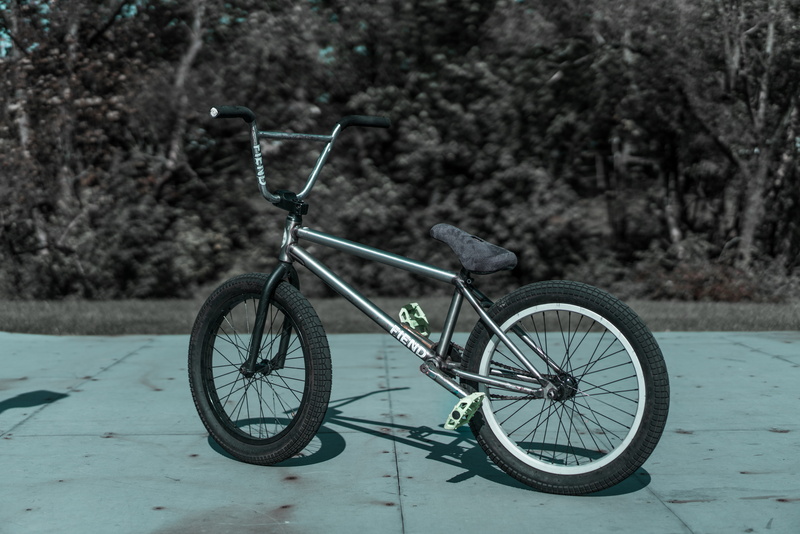 photo, outdoors, day, grayscale, city, absence, bmx, bike, wheel, spoke, skate park, container, no people, plant, concrete, street, daytime, wall, parking