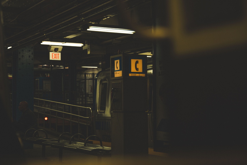 vehicle, ceiling, bench, dark, public transportation, light, street, information, subway platform, night, subway station, no people, western script, mode of transportation