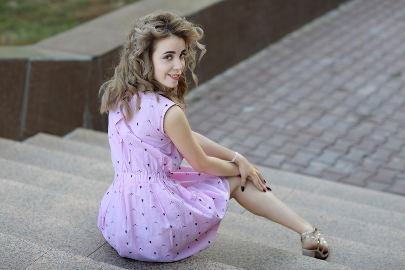young adult, young women, lifestyles, 2K, leisure activity, focus on foreground, blonde, dress, stairs, looking at camera, portrait, looking back, beautiful woman