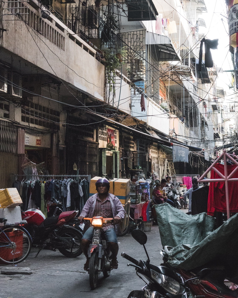 real people, cambodia, bicycle, built structure, people, day, residential district, neighbourhood, motorcycle, scooter, building, transportation, outdoors