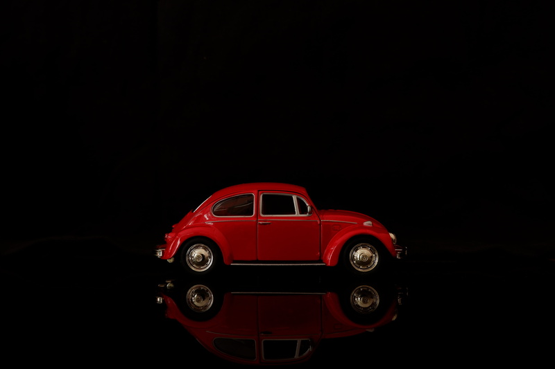 playing, play, toy, vintage, retro, red, transportation, beetle, studio shot, side view, land vehicle, kid, indoors, classic, car, funny, machine, volkswagen