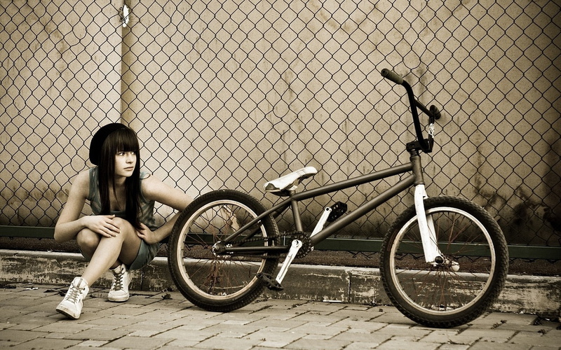 monochrome, brunette, BMX, squatting, waiting, low saturation, women with bicycles, 1080P, women outdoors, looking away, long hair, women