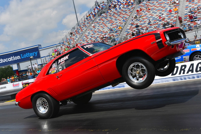 text, outdoors, camaro, car, 1080P, city, architecture, road, transportation, mode of transportation, wheel, street, motor vehicle, cloud - sky, wheelies