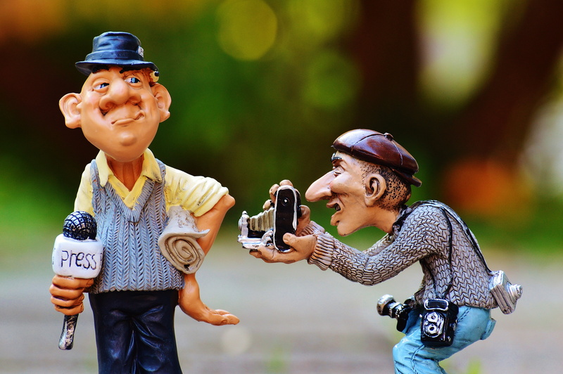 holding, commenced, mid adult, focus on foreground, outdoors, offspring, journalism, photographer, press, smiling, hat, adults only, people, information