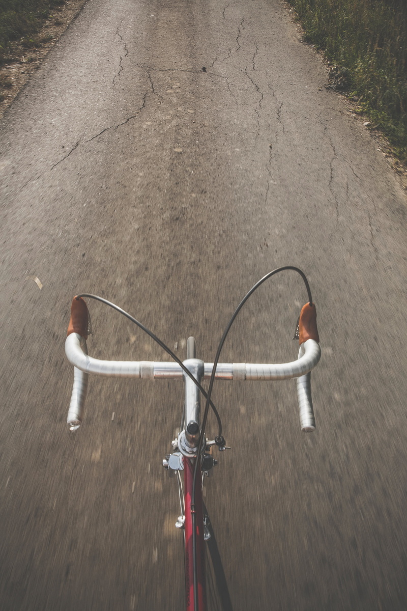 high angle view, men, day, lifestyle, outdoors, cycle, transportation, one person, riding, active, road, land vehicle, mode of transportation, handle bars