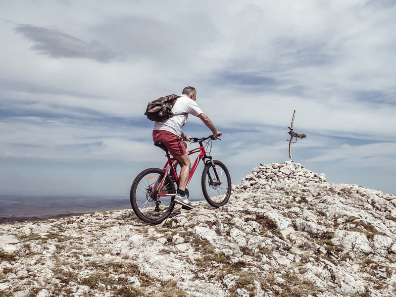 4K, peak, lifestyles, ride, biking, land, cycling, activity, real people, leisure activity, mountain, clouds, one person, rider, person, man, nature, transportation