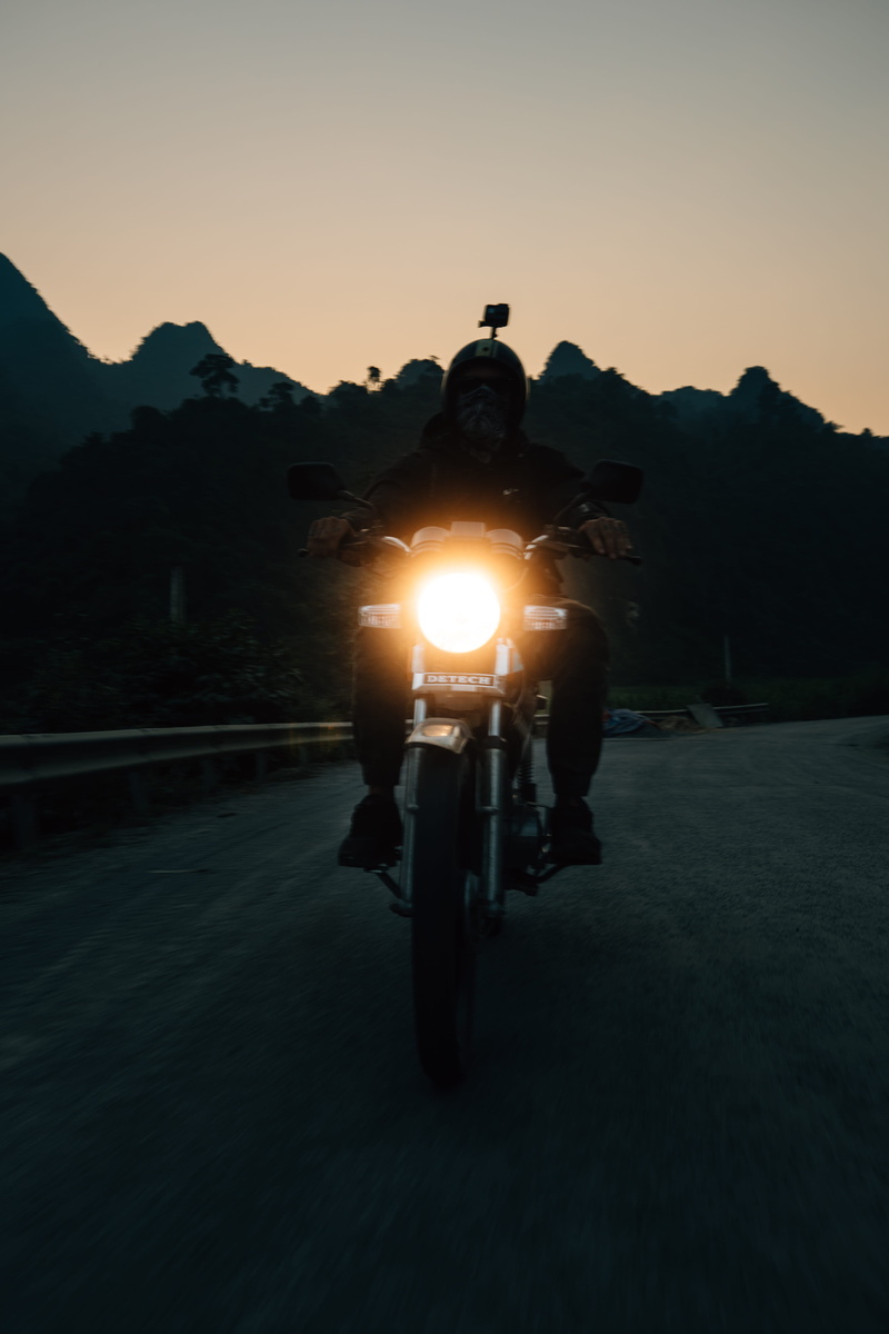 flare, nature, vehicle, copy space, hustle, one person, land vehicle, direction, riding, city, illuminated, lens flare, sky, road, real people, vietnam