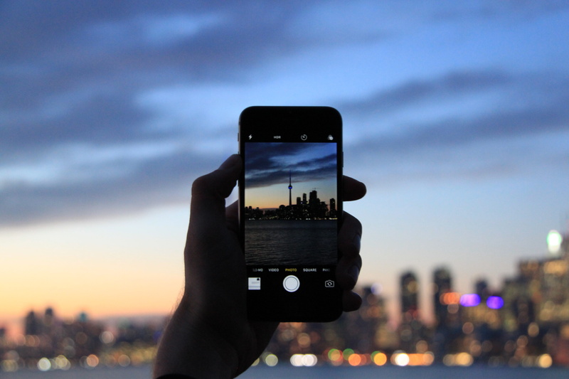 iphone, office building exterior, smart phone, toronto, one person, connection, outdoors, nature, mobile phone, holding, phone, human hand, hand, sky, photographing