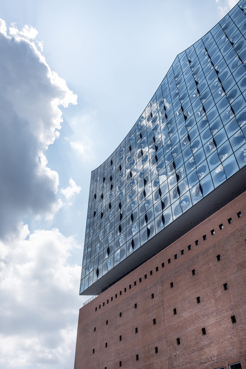 concert, facade, building, office, architecture, hafen, cloud - sky, window, exterior, sky, river, built structure, landmark, outdoors, sunlight, music