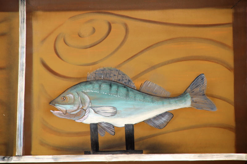 no people, close-up, indoors, herring, history, fish, street art, animal themes, building, one animal, animal representation, statue, perch, sturgeon, carving - craft product
