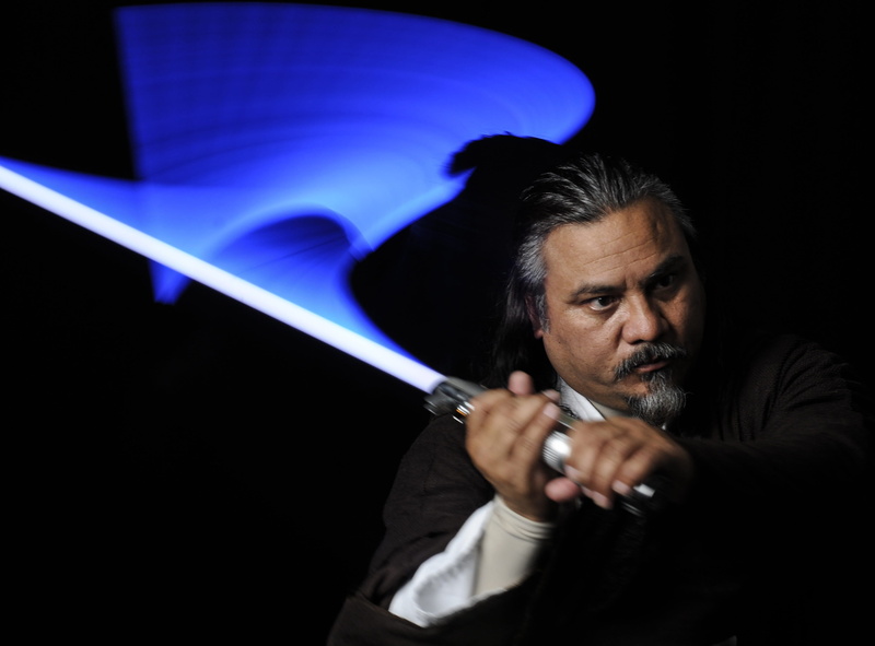 looking at camera, top, Costume, serious, light saber, caucasian Ethnicity, mature men, aggression, indoors, Character, one Person, night, weapon, mature adult