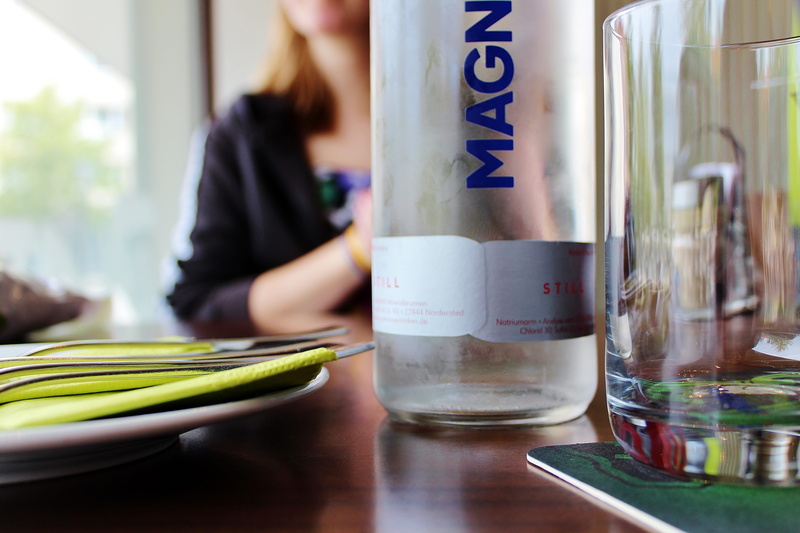 bottle, household equipment, meeting, menu, blur, focus on foreground, glass, food, table, indoors, vegetable, casual clothing, beside, nutrition, still life