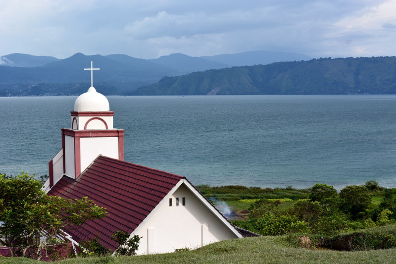 travel, building exterior, tourism, symbol, sumatra, outdoors, built structure, tower, samosir, religion, sumatera, building, mountain, church, architecture