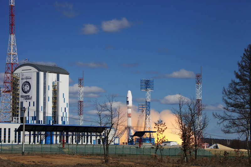 bare tree, building, tree, outdoors, factory, Roscosmos, day, sky, industry, industrial building, tower, Vostochny Cosmodrome, architecture, communication