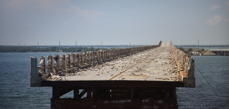 beauty in nature, destroyed, in a row, break up, outdoors, destruction, tranquil scene, water, transportation, bridge, lapsed, day, wooden post, ruin, demolished