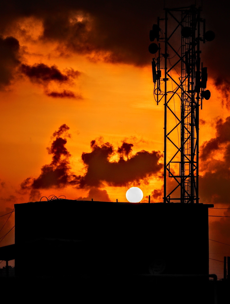 tower, fossil fuel, fuel, metal, cloud - sky, gasoline, orange color, nature, clouds, power supply, low angle view, building exterior, no people, communication