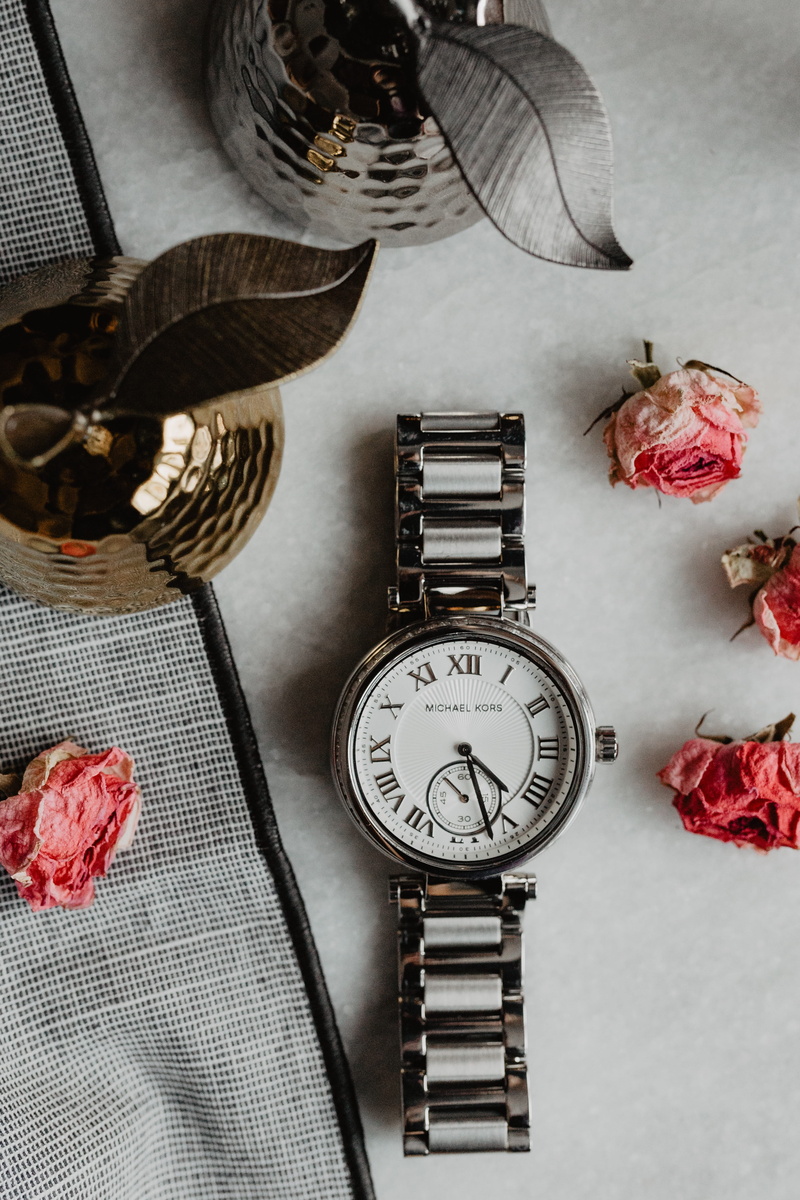 essentials, clothing, indoors, distillation, close-up, textile, flower, silver, directly above, feminine, no people, publication, watch, flat lay, pocket watch