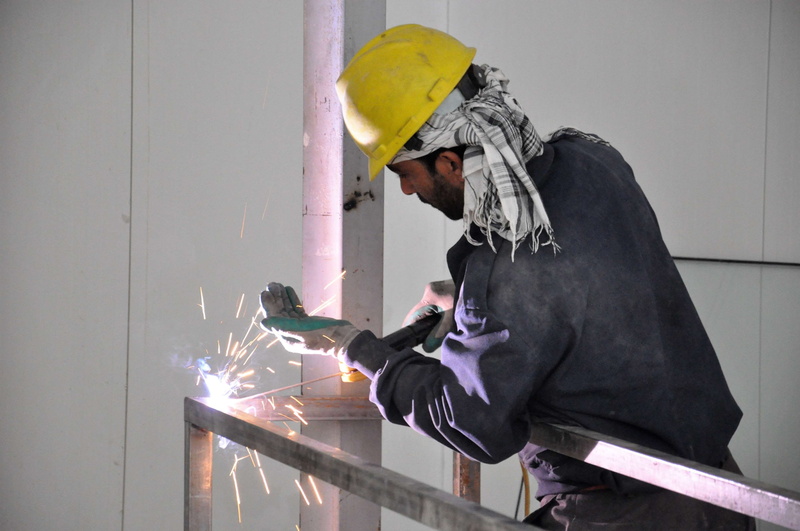 sparks, holding, steel, work tool, metal, indoors, occupation, welder, one person, work, protection, metalworking, mature men, construction, working, protective glove