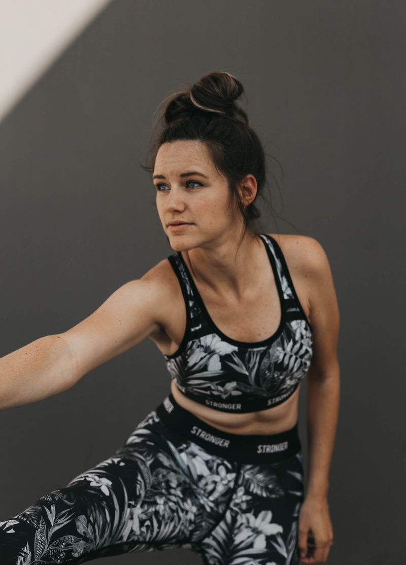 looking at camera, human, gray background, sport, adult, confidence, real people, undershirt, women, hairstyle, leisure activities, standing, fitness, portrait