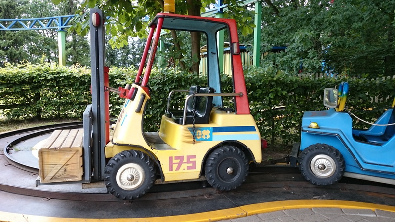 industry, mode of transportation, man made object, no people, golf cart, machinery, motor vehicle, yellow, nature, man made, erse park, theme park, wheel