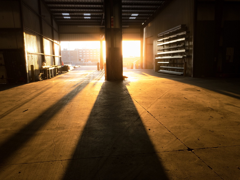 built structure, empty, garage, day, flooring, shipping, architectural column, shadow, tile, loading, storage, ceiling, industrial, bay, glowing, absence