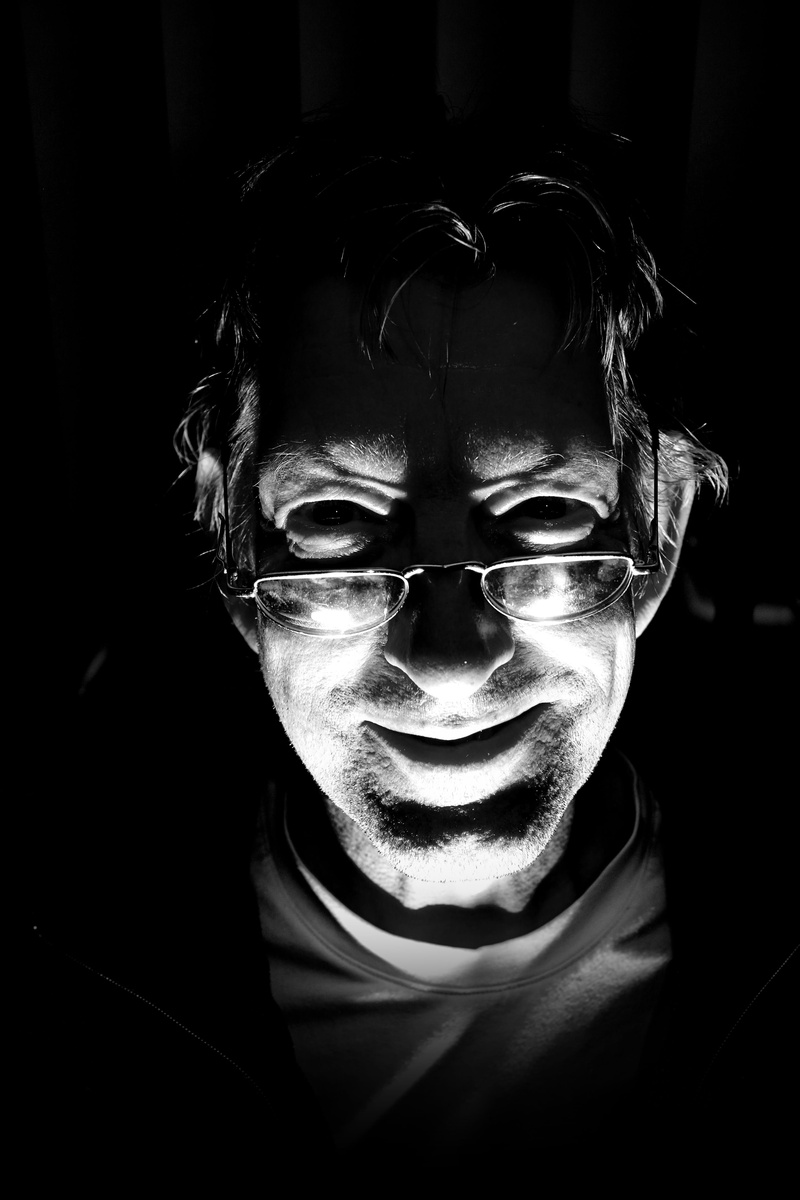 close-up, human, night photograph, black background, face, leisure activity, mood, mystical, real people, lighting, mid adult, headshot, human face, man