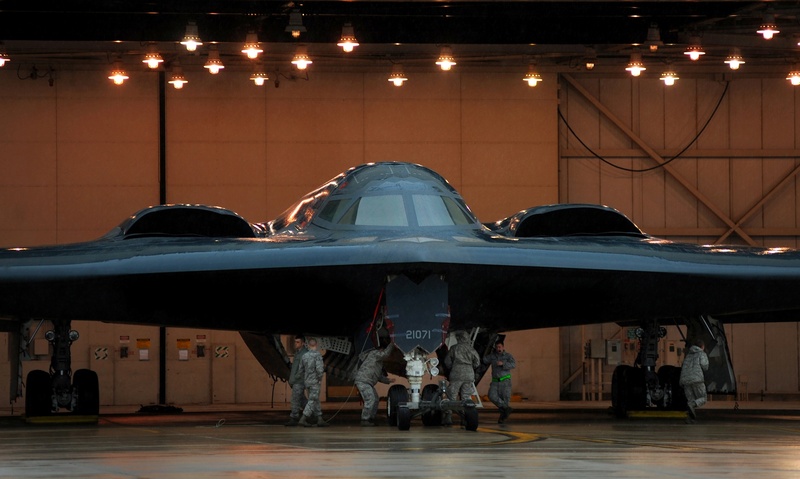 b2 spirit, air vehicle, mode of transportation, person, aerospace industry, front view, walking, stealth bomber jet, mechanics, education, airport, dusk
