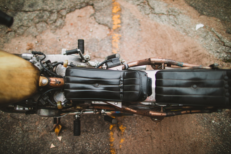 black color, transportation, black, gun, weaponry, motor, gray, wheel, holding, outdoors, low section, grenade, vehicle, drive shaft, military, coil, bomb